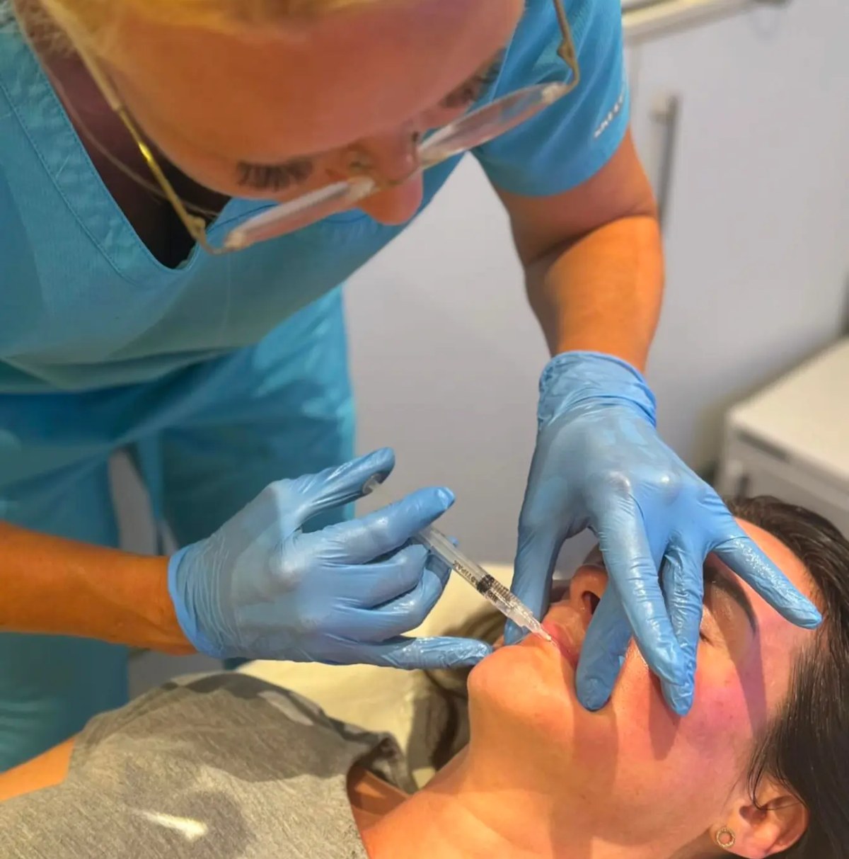 Practitioner carrying out a facial treatment